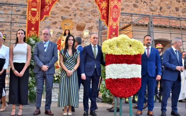 Vecinos depositando flores ante la Virgen de Gracia en la ofrenda floral de las fiestas patronales de Puertollano